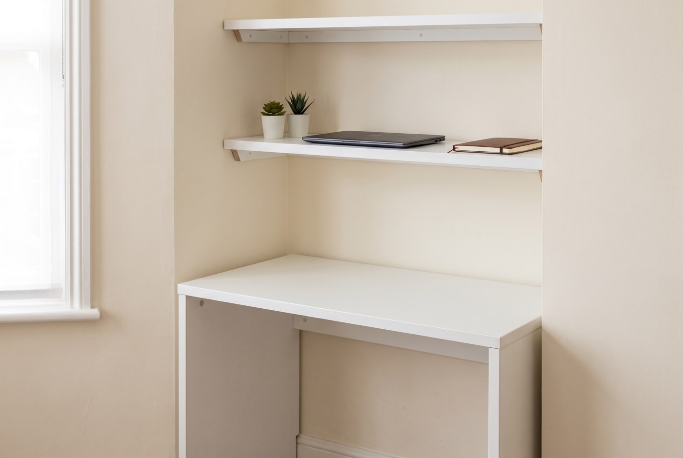 Illustration of a white fitted desk and shelves